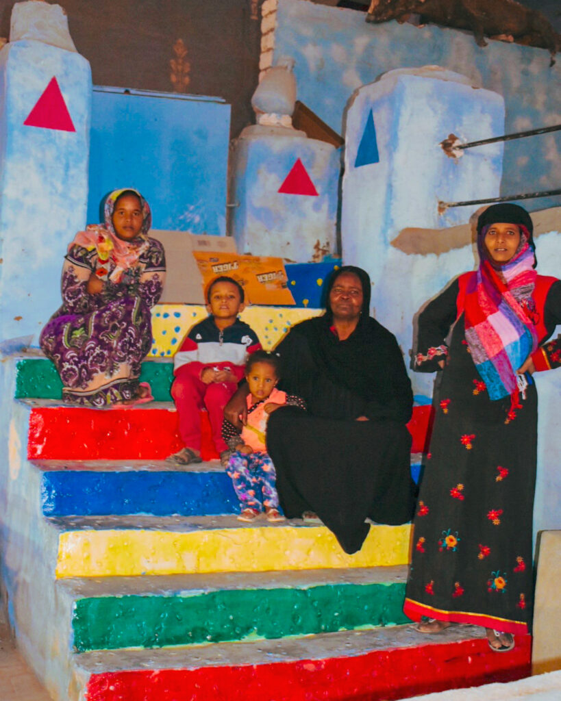 Nubian women on colourful steps in the Nubian Village