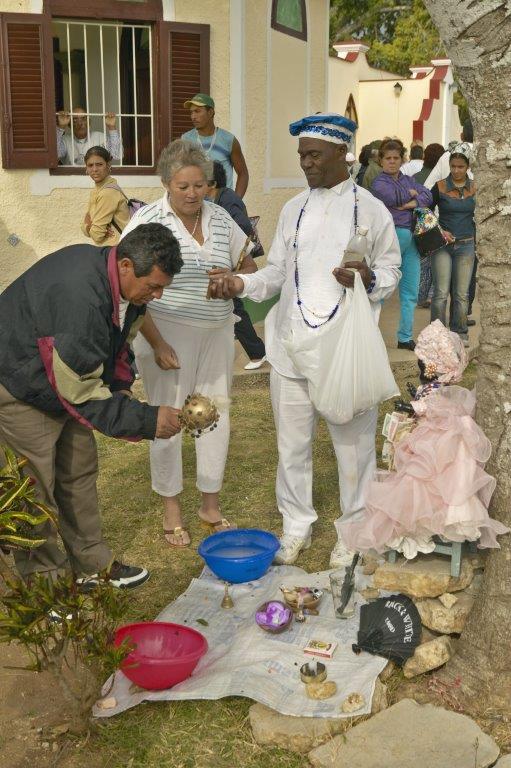 San Lazaro Catholic Church with Santería priest offering services in El Rincon, Cuba - med