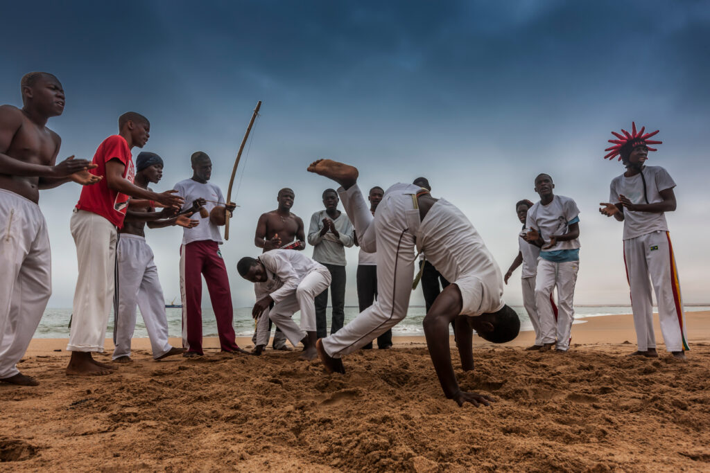 What is Capoeira - you men performing Capoeira on the beach in Angola