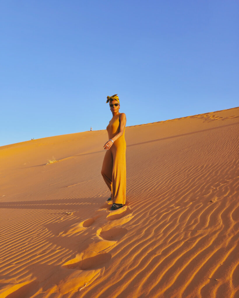 Merzouga Sahara Desert tour.  Walking up dune